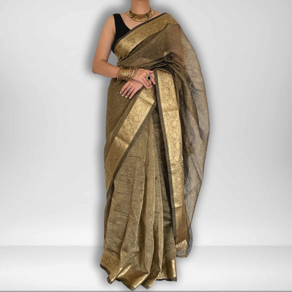 Dark grey crush tissue saree with Banarasi border and golden zari work, Work by Shobhangini. Sophisticated dark grey saree, ideal for evening events.