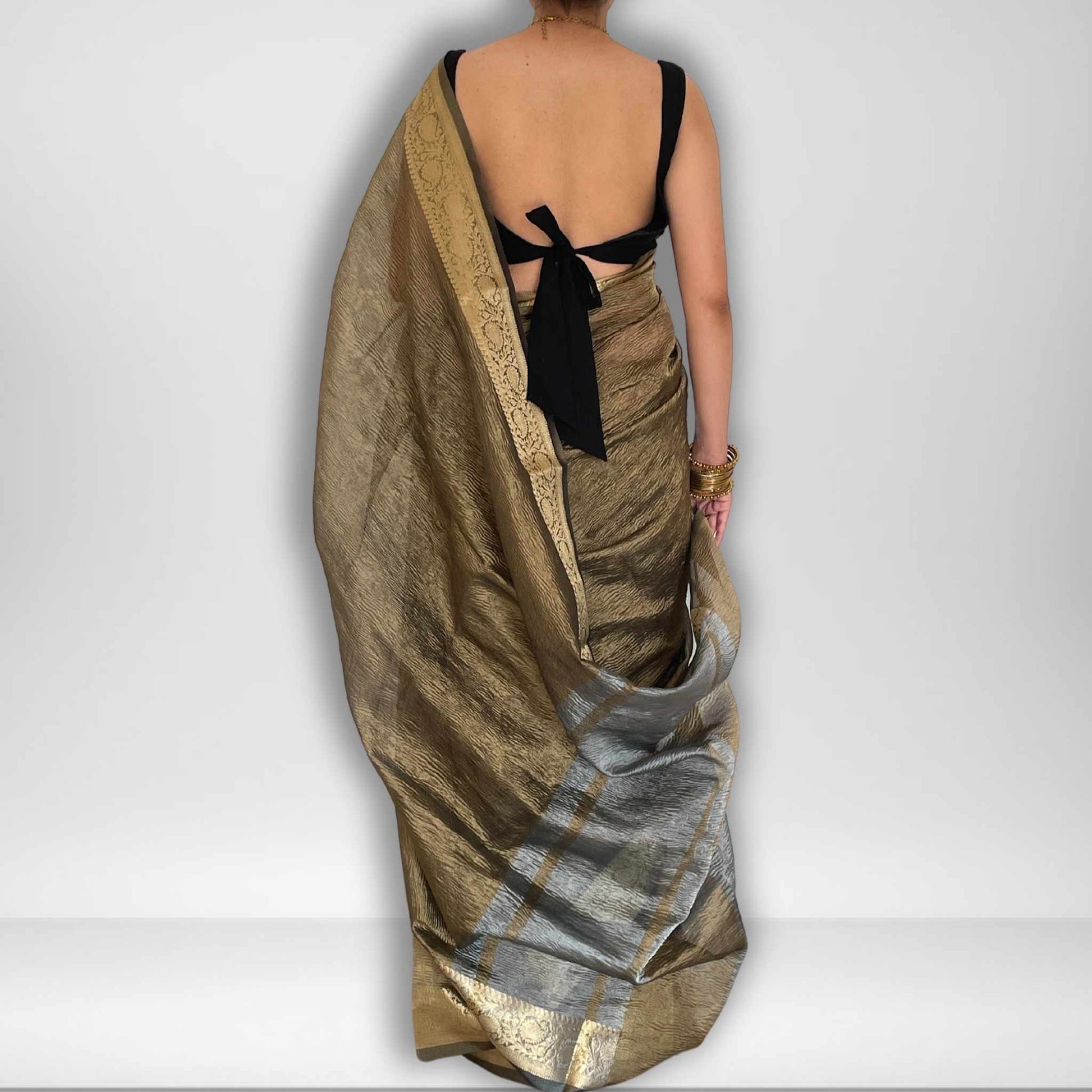 Dark grey crush tissue saree with Banarasi border and golden zari work, Work by Shobhangini. Sophisticated dark grey saree, ideal for evening events.