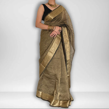 Dark grey crush tissue saree with Banarasi border and golden zari work, Work by Shobhangini. Sophisticated dark grey saree, ideal for evening events.