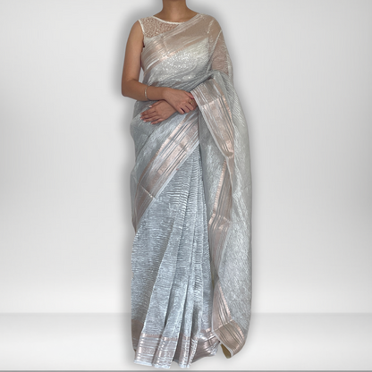 Silver metallic crush tissue saree with copper zari border, Work by Shobhangini. Modern silver saree, perfect for cocktail parties.