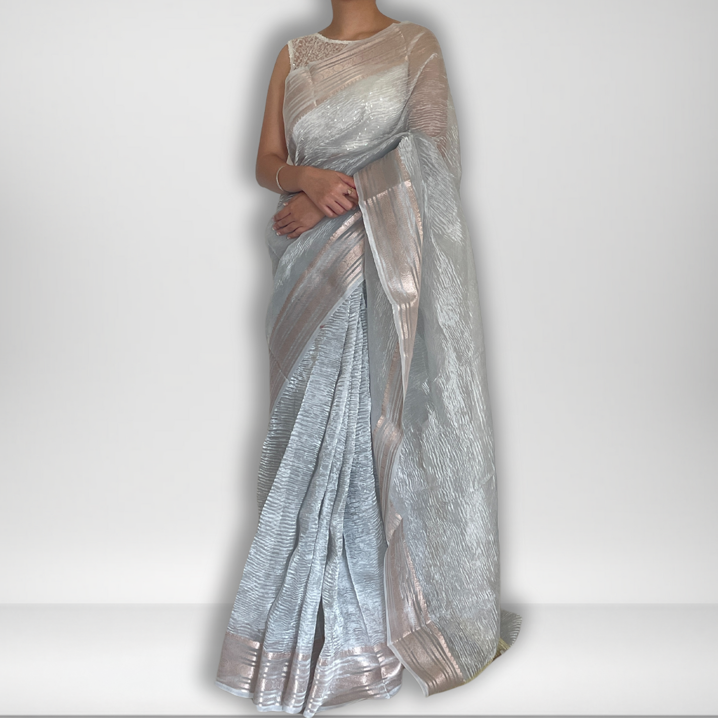 Silver metallic crush tissue saree with copper zari border, Work by Shobhangini. Modern silver saree, perfect for cocktail parties.