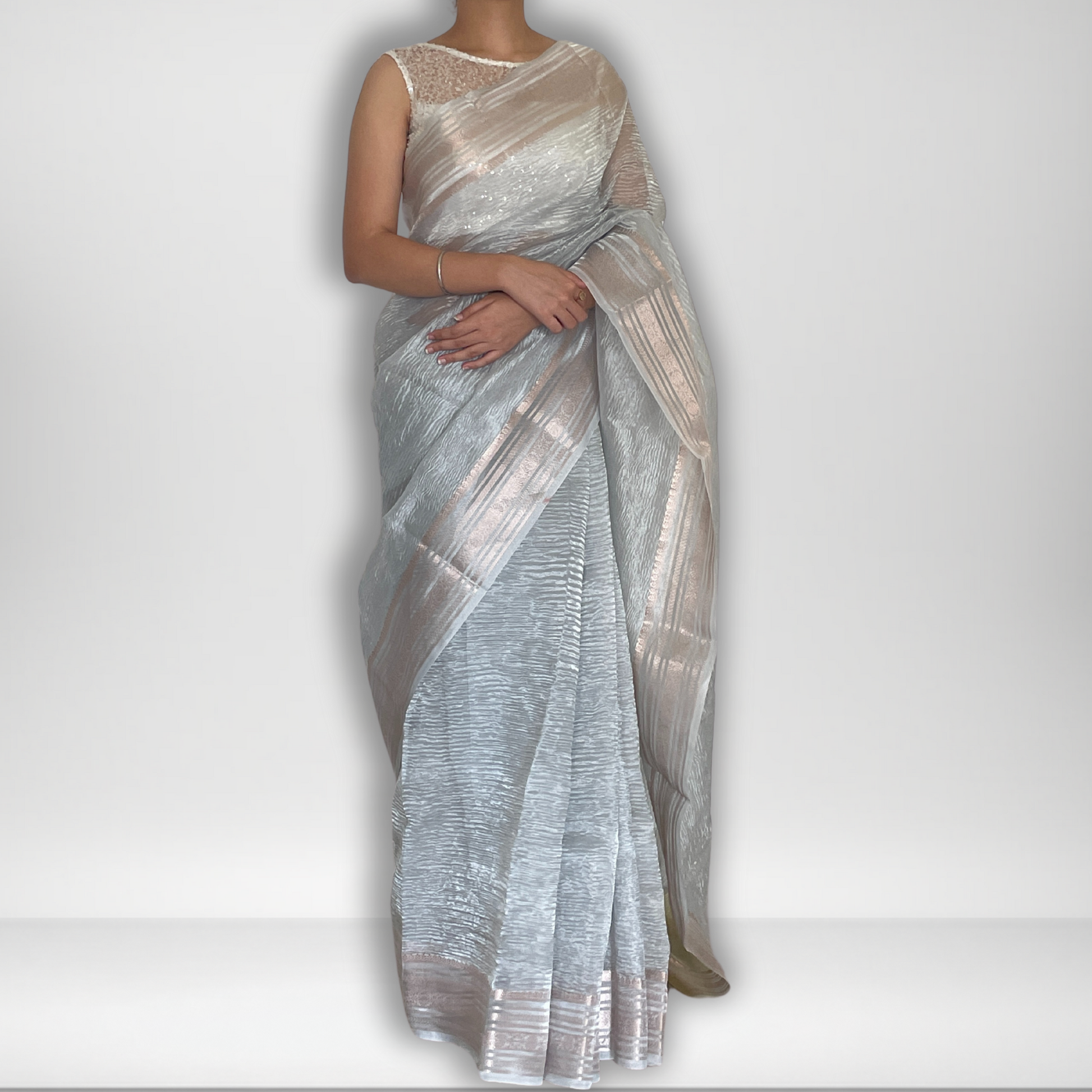 Silver metallic crush tissue saree with copper zari border, Work by Shobhangini. Modern silver saree, perfect for cocktail parties.