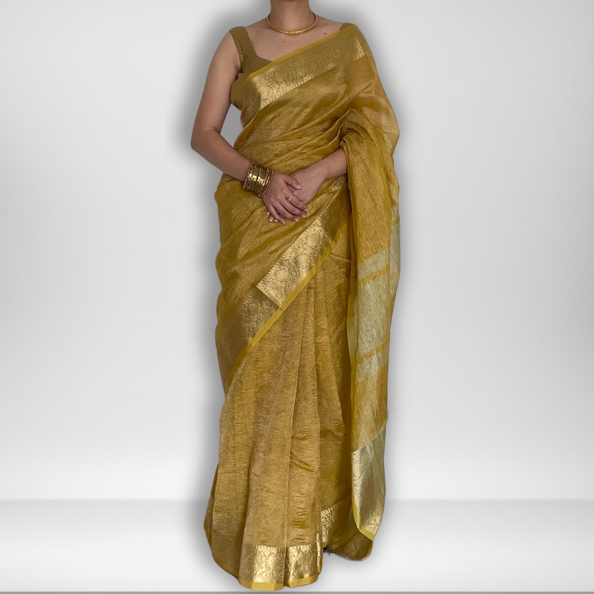 Yellow crush tissue saree with Banarasi border and golden zari work, Work by Shobhangini. Vibrant yellow saree, ideal for summer festivities.