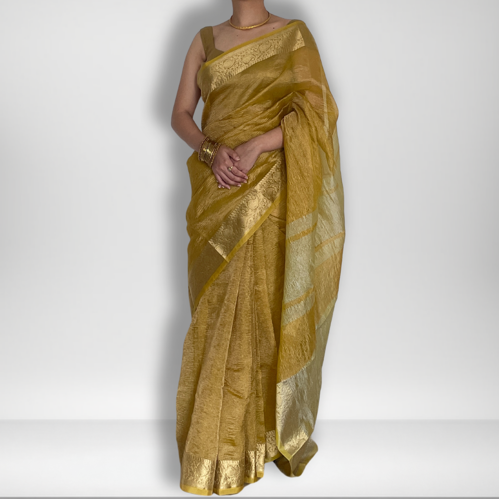 Yellow crush tissue saree with Banarasi border and golden zari work, Work by Shobhangini. Vibrant yellow saree, ideal for summer festivities.