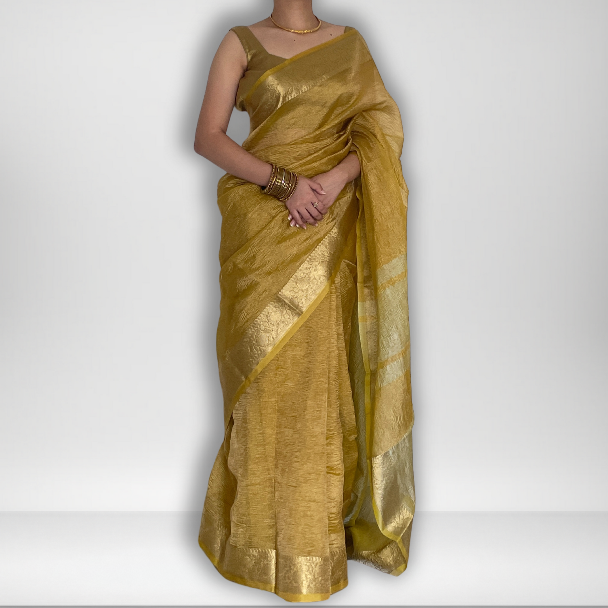 Yellow crush tissue saree with Banarasi border and golden zari work, Work by Shobhangini. Vibrant yellow saree, ideal for summer festivities.