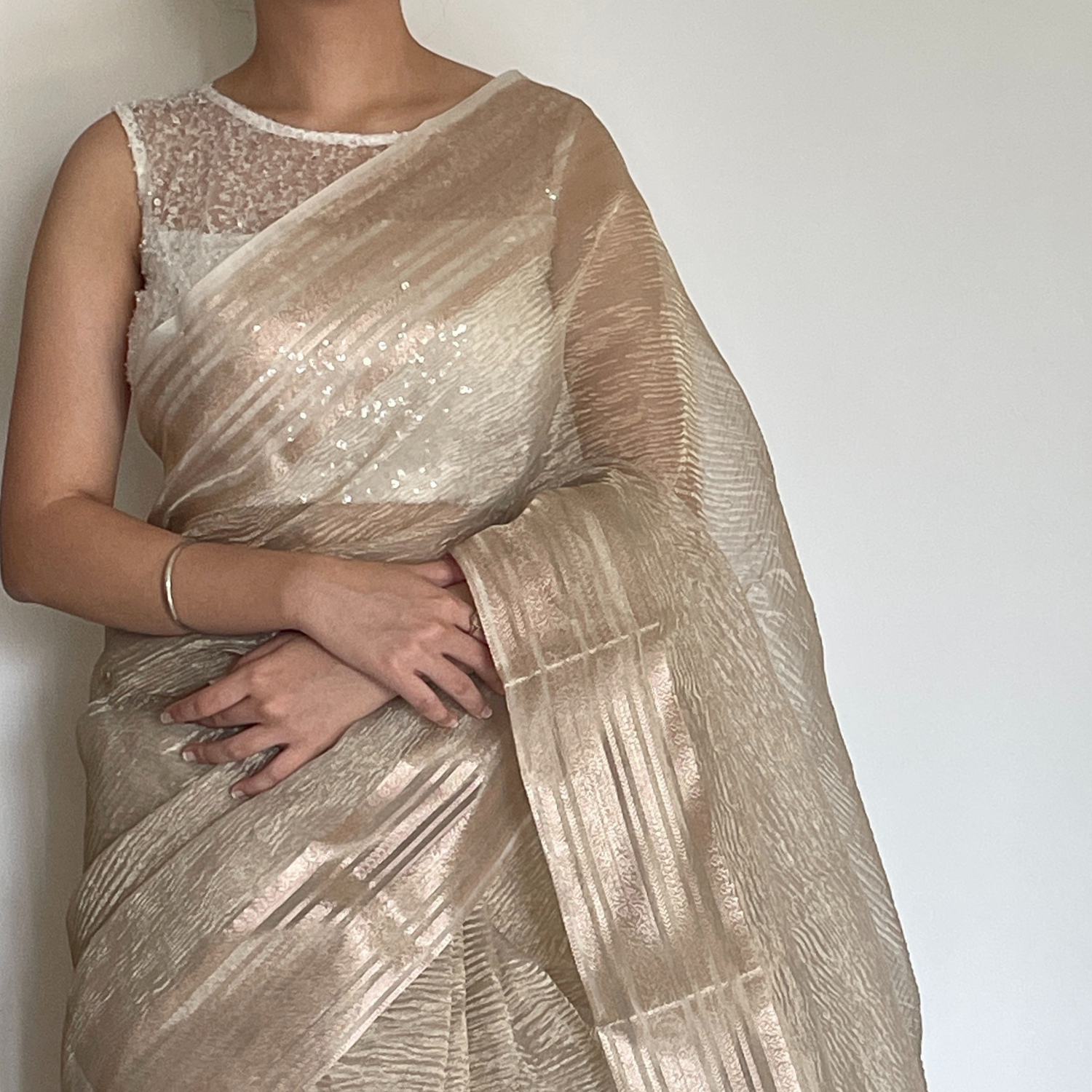 Light gold metallic crush tissue saree with copper zari border, Work by Shobhangini. Delicate light gold saree, perfect for day events.