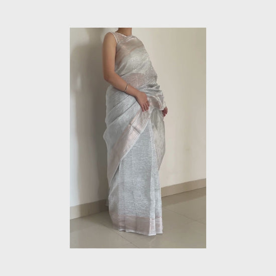 Silver metallic crush tissue saree with copper zari border, Work by Shobhangini. Modern silver saree, perfect for cocktail parties.