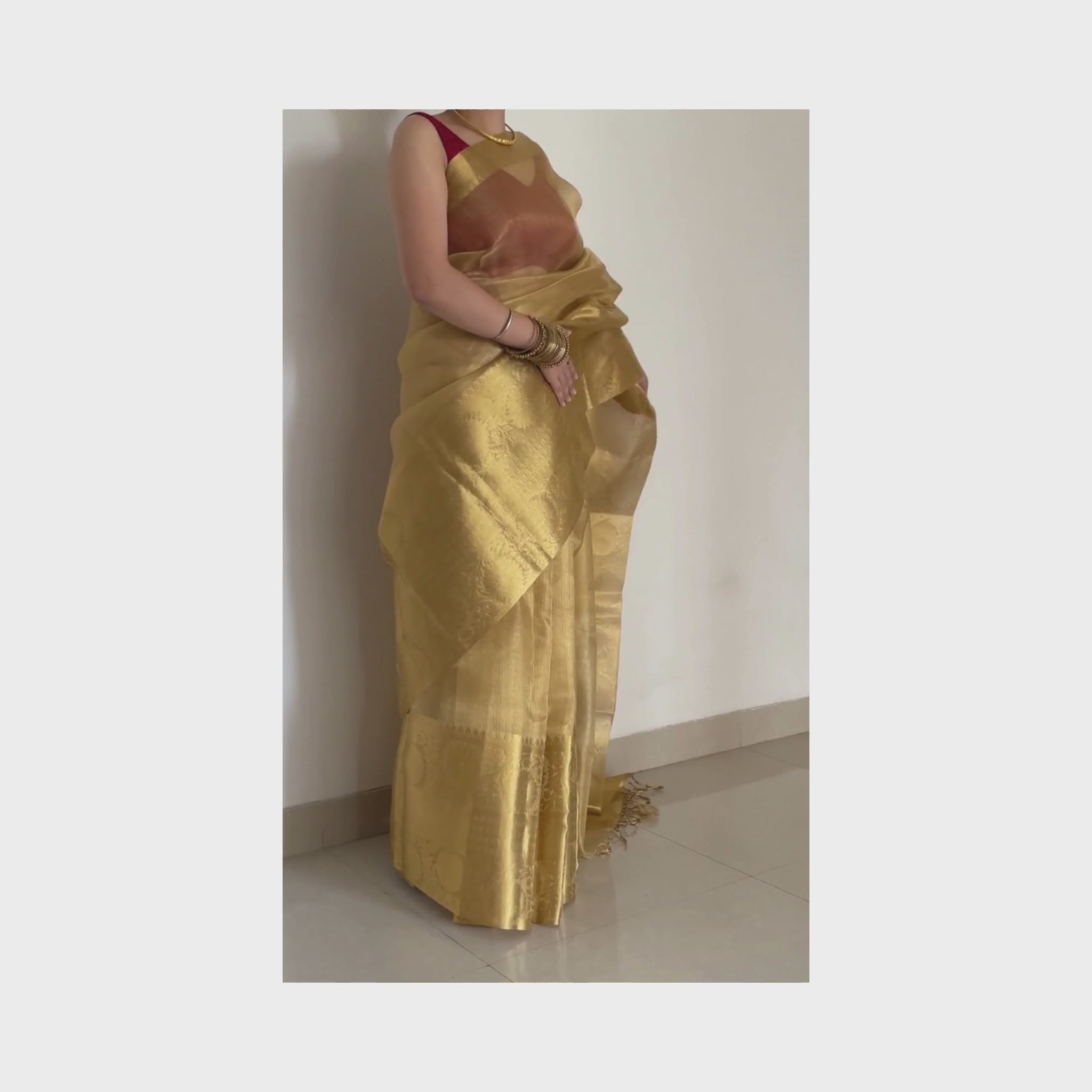 Golden tissue saree with intricate zari border, Work by Shobhangini. Luxurious golden saree, perfect for weddings and festive occasions.